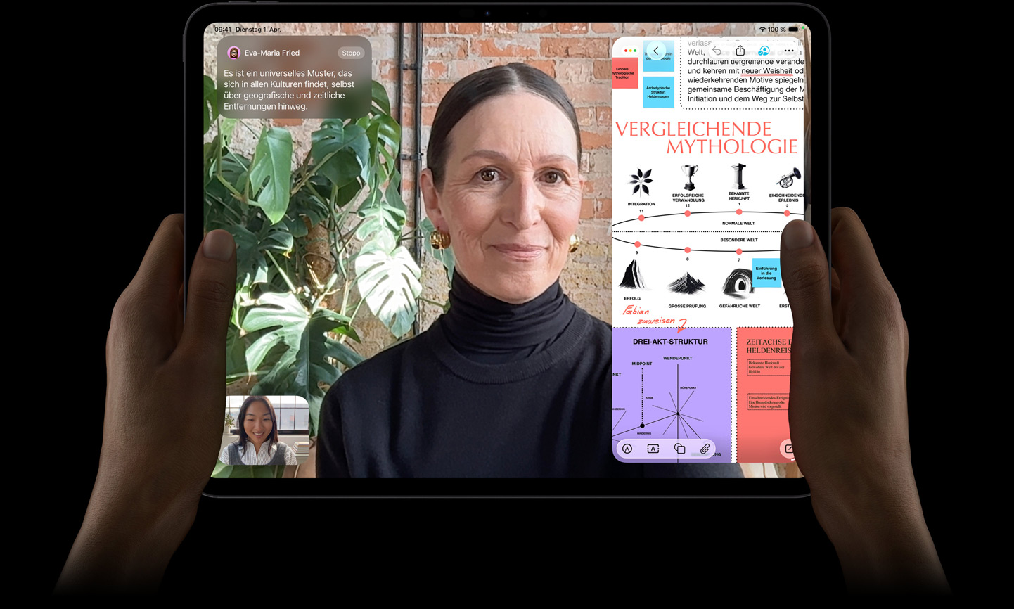 iPad Pro, Vorderansicht, Farbe Space Schwarz, linke und rechte Hand halten es im Querformat, gerundete Ecken, schwarzer Displayrand, das Display zeigt ein FaceTime Gespr?ch, das live übersetzt wird, und eine Lernapp zeigt eine Pr?sentation zu ?Vergleichende Mythologie“ mit Text, Diagrammen und handschriftlichen Notizen